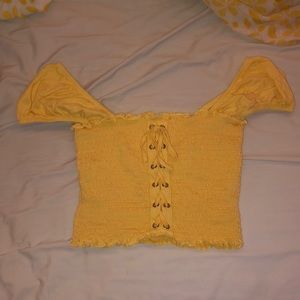 off the shoulder yellow shortsleeved shirt